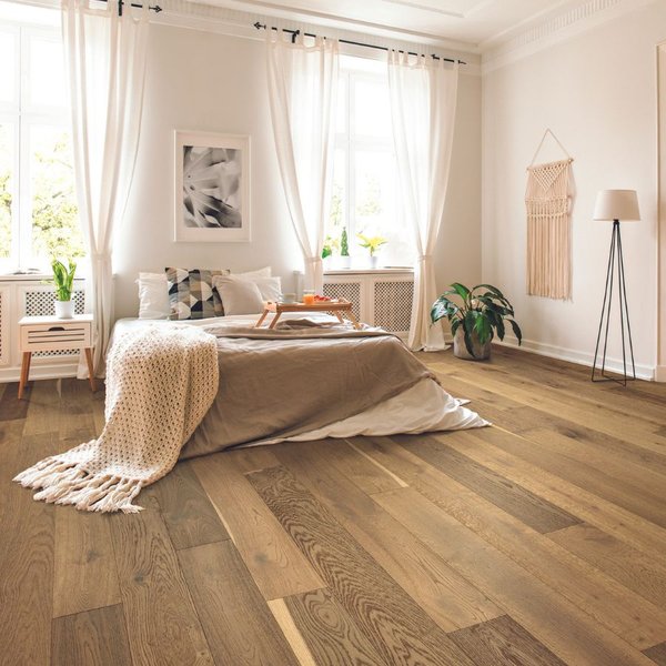 light hardwood floors in a large bedroom with neutral tones
